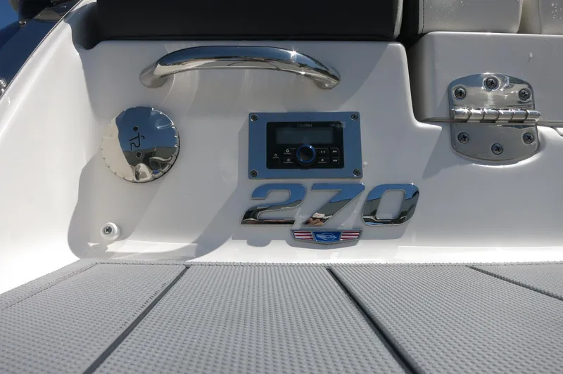 Slide: The Image of 2025 Chaparral 270 OSX boat deck with control panel and chrome details. - 11