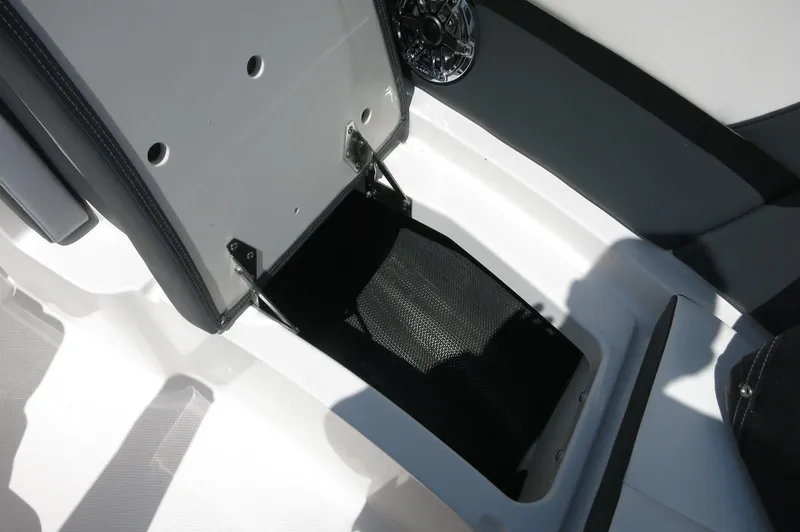 Slide: The Image of 2025 Chaparral 270 OSX boat storage compartment with open hatch and speaker. - 19