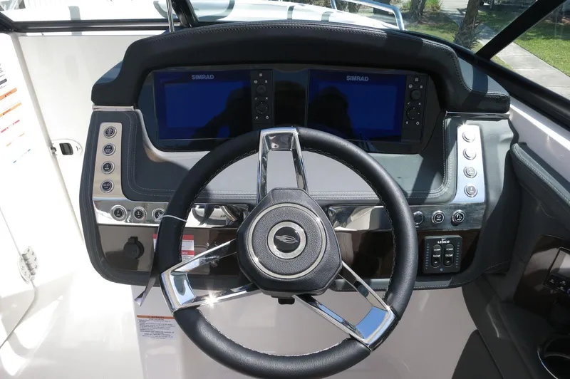 Slide: The Image of Steering console of 2025 Chaparral 270 OSX boat with dual Simrad displays. - 27
