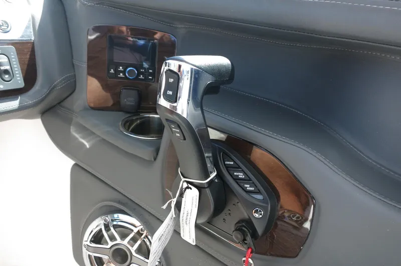 Slide: The Image of Control panel of 2025 Chaparral 270 OSX boat with throttle and speaker. - 28