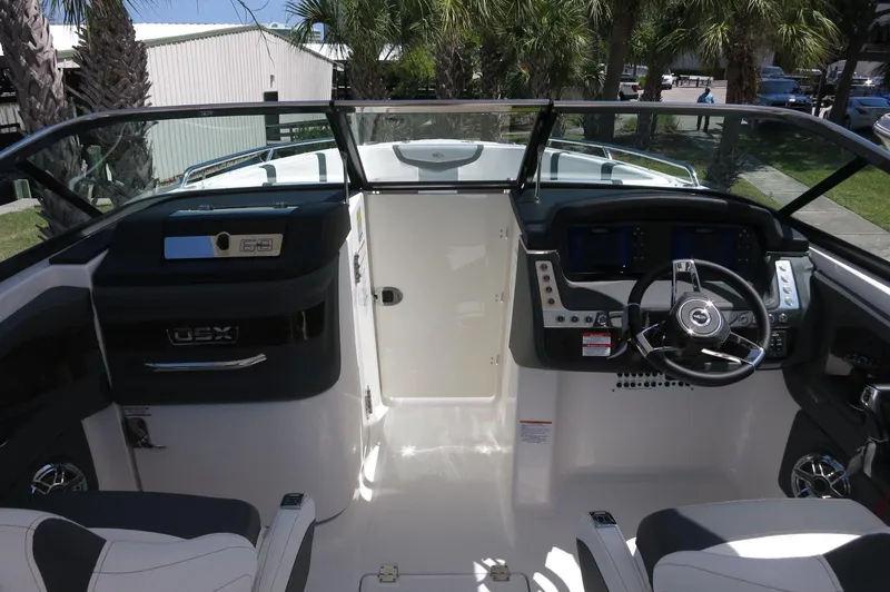 Slide: The Image of 2025 Chaparral 270 OSX boat cockpit with modern steering and control panel. - 29
