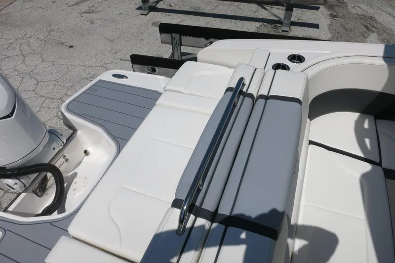 Slide: The Image of 2025 Chaparral 270 OSX boat interior with white seating and cup holders. - 35