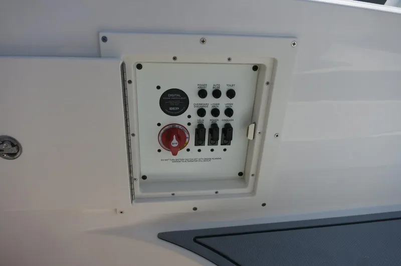 Slide: The Image of Control panel on 2025 Chaparral 270 OSX boat, featuring switches and a red power knob. - 39