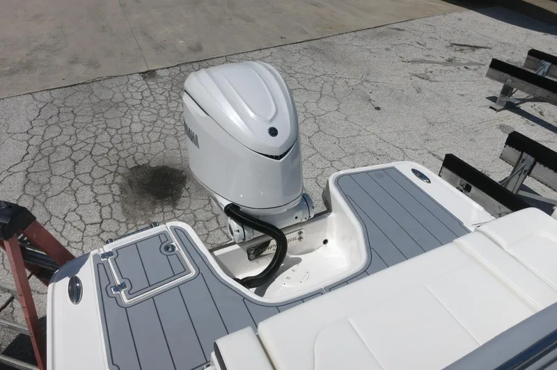 Slide: The Image of 2025 Chaparral 270 OSX boat with sleek outboard motor and modern deck design. - 40