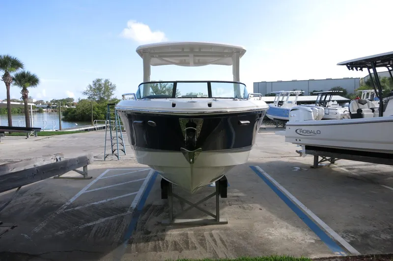 Slide: The Image of 2025 Chaparral 270 OSX boat on display in a marina setting. - 43