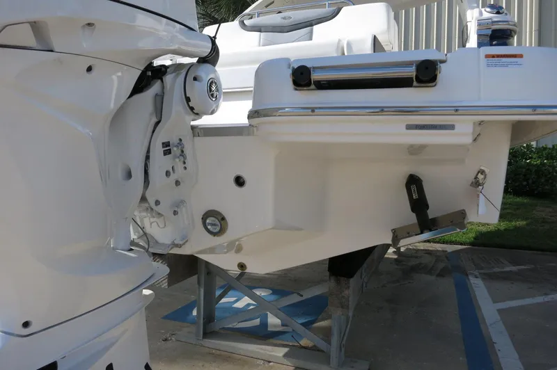 Slide: The Image of 2025 Chaparral 270 OSX boat stern with outboard motor and trim tab. - 47