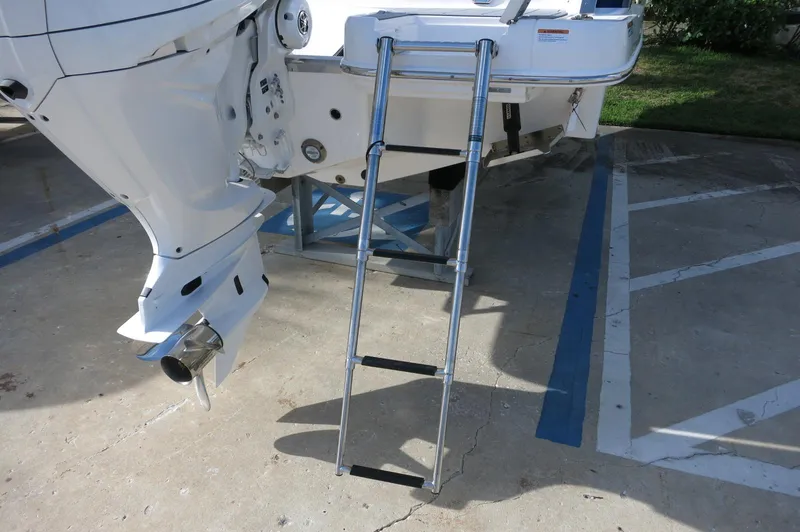 Slide: The Image of Rear view of 2025 Chaparral 270 OSX boat with ladder and outboard motor. - 48