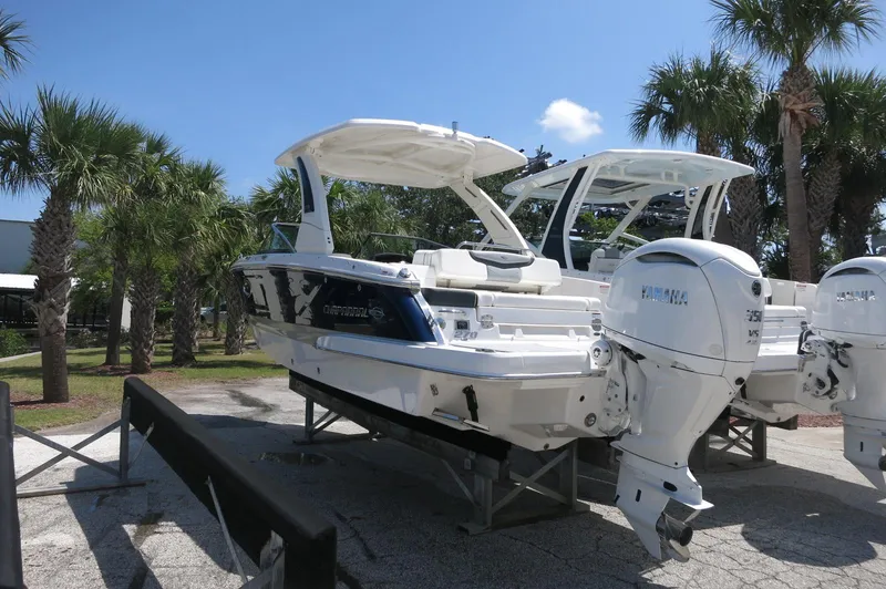 Slide: The Image of 2025 Chaparral 270 OSX boat with Yamaha engines, displayed outdoors near palm trees. - 6
