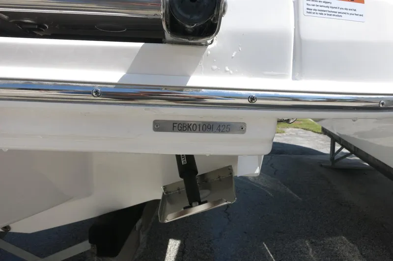 Slide: The Image of 2025 Chaparral 270 OSX boat stern with identification plate and trim tab. - 8