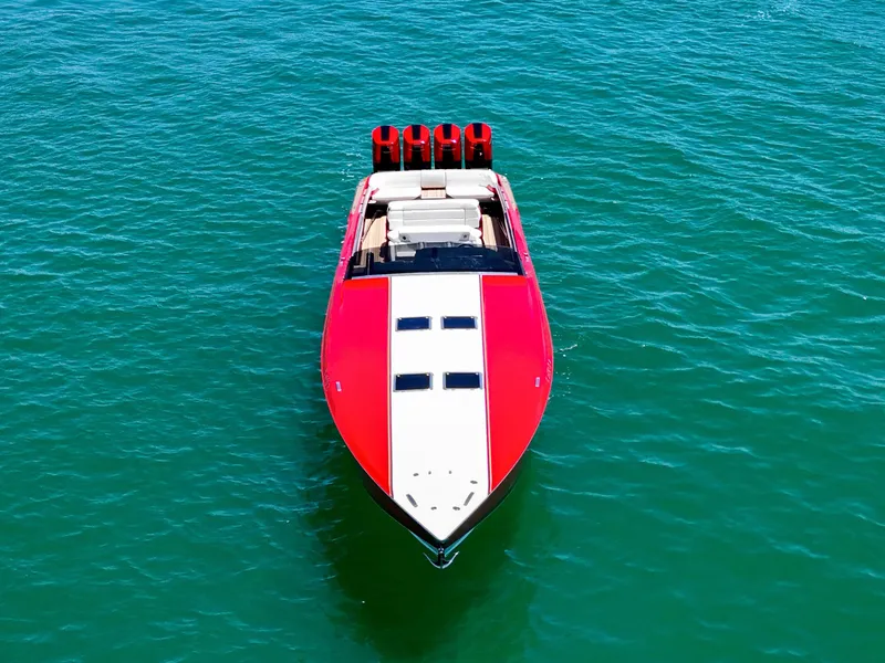 Slide: The Image of Red 2023 Nor-Tech 55 Flyer boat on clear blue water, aerial view. - 11