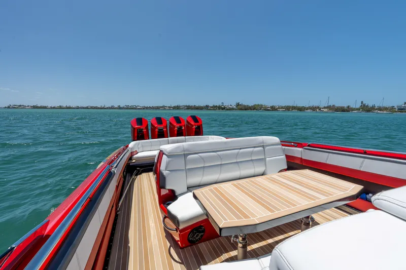 Slide: The Image of 2023 Nor-Tech 55 Flyer boat with luxurious seating and table on open water. - 30