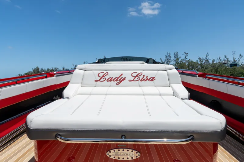 Slide: The Image of 2023 Nor-Tech 55 Flyer boat with "Lady Lisa" on white seating, under clear blue sky. - 33
