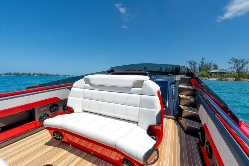 Slide: The Image of Luxurious 2023 Nor-Tech 55 Flyer boat interior with white seating, red accents, and scenic ocean view. - 38