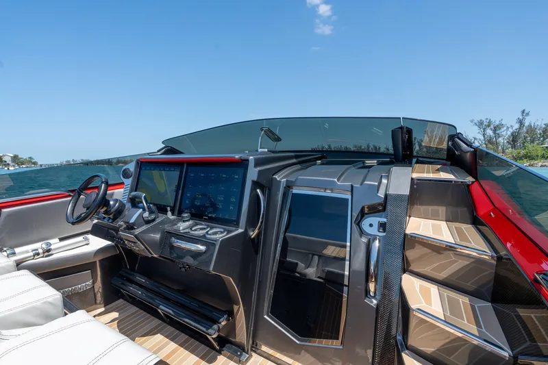 Slide: The Image of 2023 Nor-Tech 55 Flyer cockpit with modern controls and luxurious seating. - 39