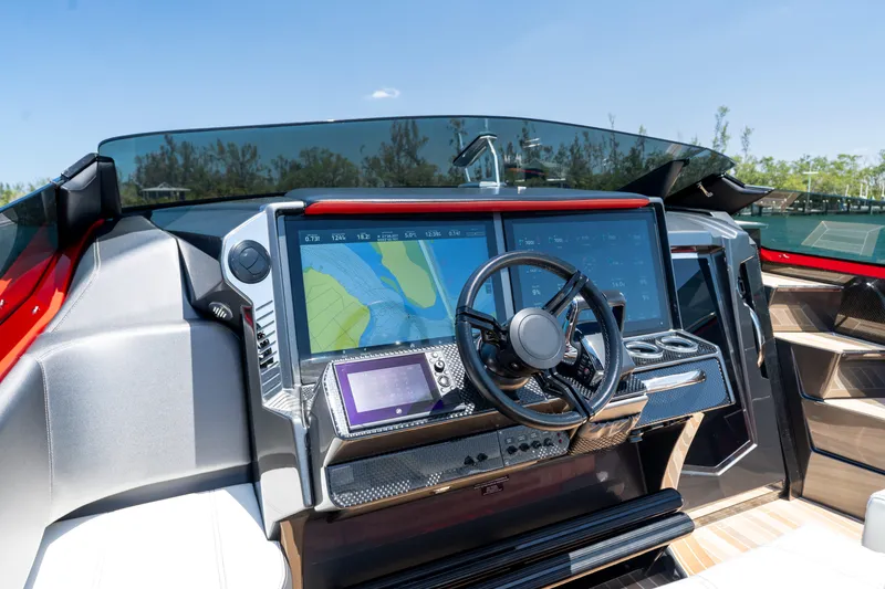 Slide: The Image of Cockpit of 2023 Nor-Tech 55 Flyer with advanced navigation displays and steering wheel. - 41