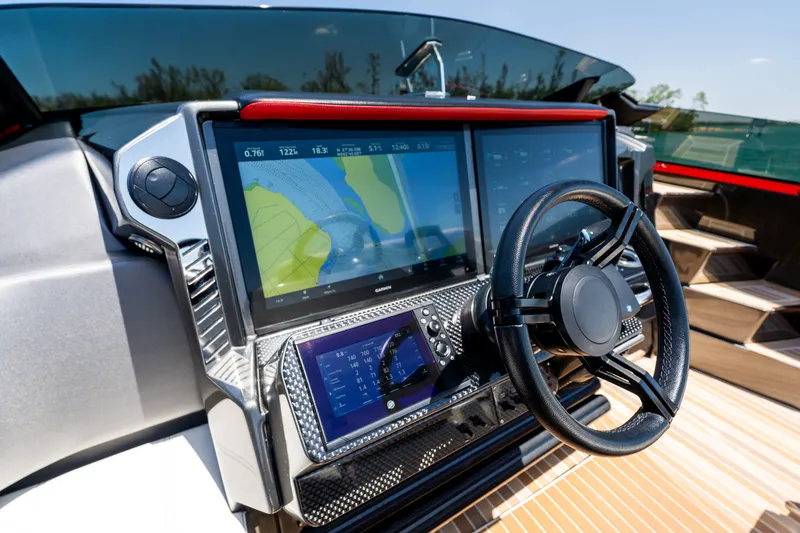 Slide: The Image of 2023 Nor-Tech 55 Flyer dashboard with advanced navigation screens and steering wheel. - 44