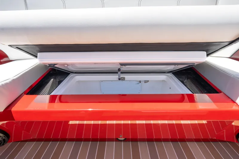 Slide: The Image of Open storage compartment on 2023 Nor-Tech 55 Flyer boat with red and white seating. - 46