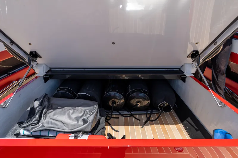 Slide: The Image of Open storage compartment of 2023 Nor-Tech 55 Flyer boat with equipment inside. - 47