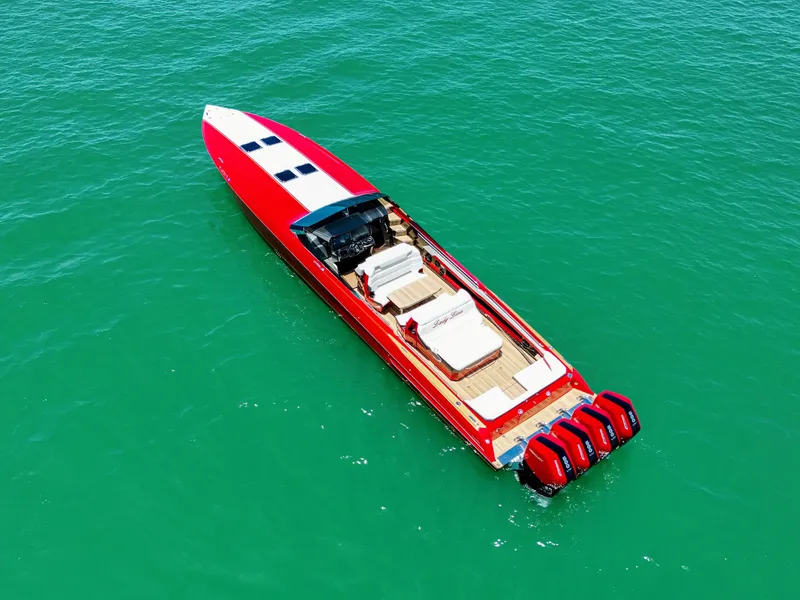 Slide: The Image of 2023 Nor-Tech 55 Flyer boat with red exterior on turquoise water. - 8