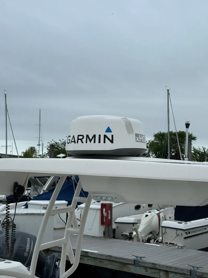 Slide: The Image of 2022 Robalo R247 Dual Console with Garmin xHD radar at marina. - 14