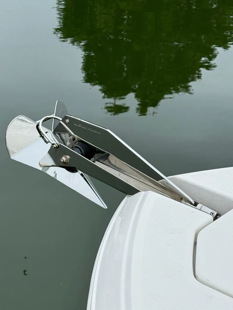 Slide: The Image of Anchor of 2022 Robalo R247 Dual Console boat on calm water. - 15
