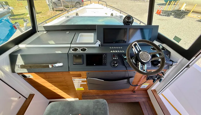Slide: The Image of 2019 Axopar AX37XC boat cockpit with modern steering and navigation controls. - 10