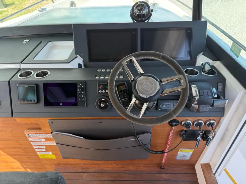 Slide: The Image of 2019 Axopar AX37XC boat dashboard with steering wheel and navigation controls. - 11