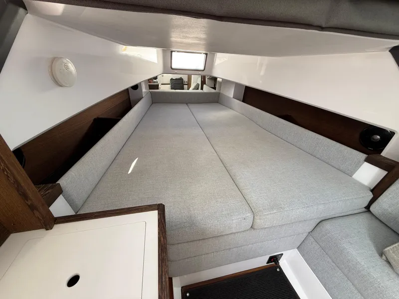 Slide: The Image of 2019 Axopar AX37XC cabin interior with gray cushions and wooden accents. - 15