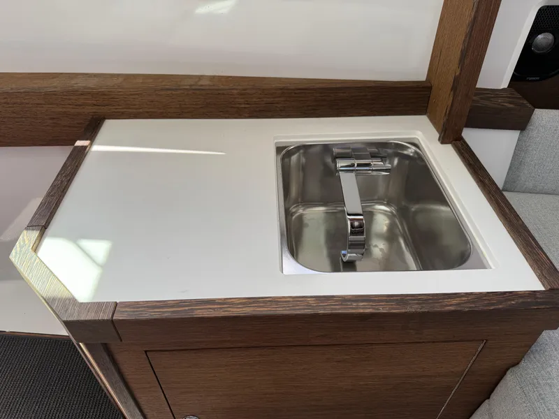 Slide: The Image of 2019 Axopar AX37XC boat interior with a sleek stainless steel sink and modern faucet. - 16