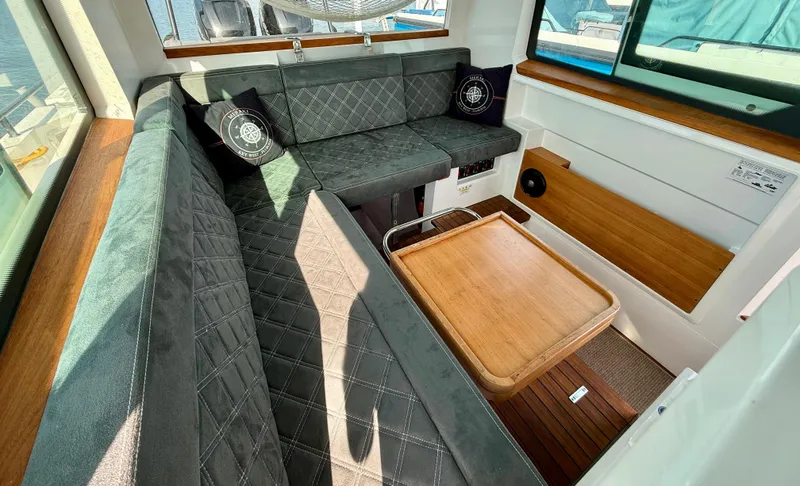 Slide: The Image of Luxurious interior of 2019 Axopar AX37XC boat with plush seating and wooden accents. - 21