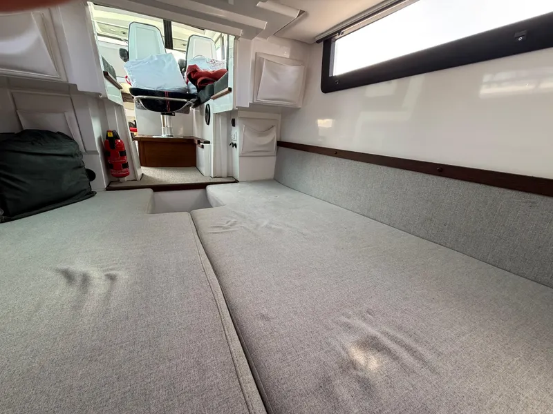 Slide: The Image of Interior cabin of 2019 Axopar AX37XC boat with gray seating and fire extinguisher. - 26