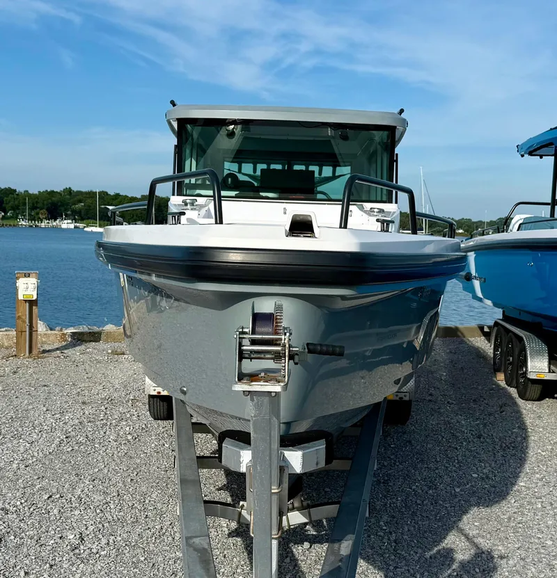 Slide: The Image of 2019 Axopar AX37XC boat on trailer by the water, front view. - 3