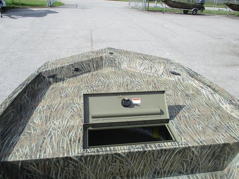Slide: The Image of 2026 Tracker Grizzly 1860 CC boat with camouflage design and open storage compartment. - 10