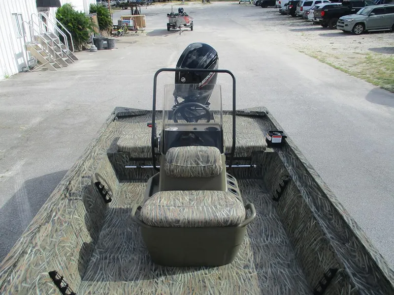 Slide: The Image of 2026 Tracker Grizzly 1860 CC boat with camouflage interior and outboard motor. - 11