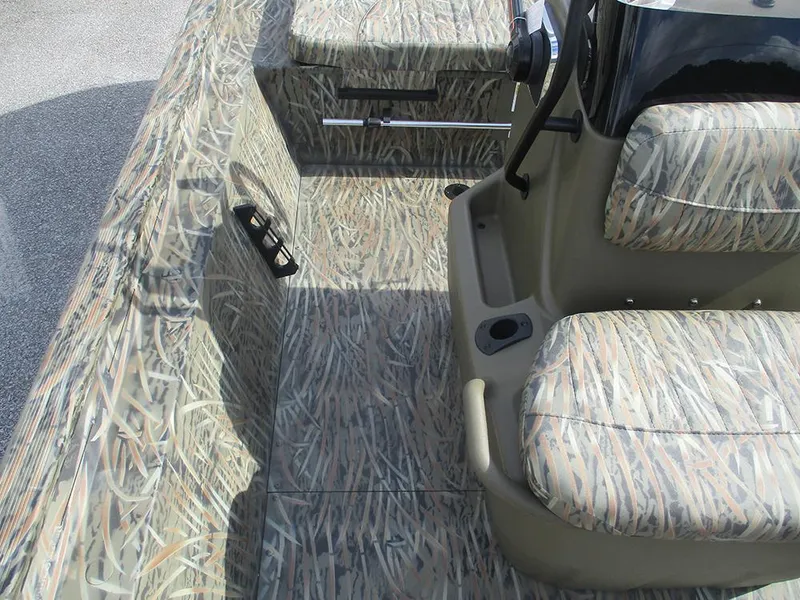 Slide: The Image of 2026 Tracker Grizzly 1860 CC boat interior with camouflage seating and flooring design. - 15