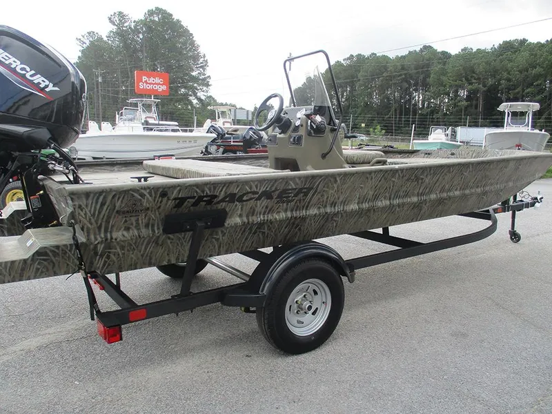 Slide: The Image of 2026 Tracker Grizzly 1860 CC boat on trailer, camo design, parked outdoors. - 5