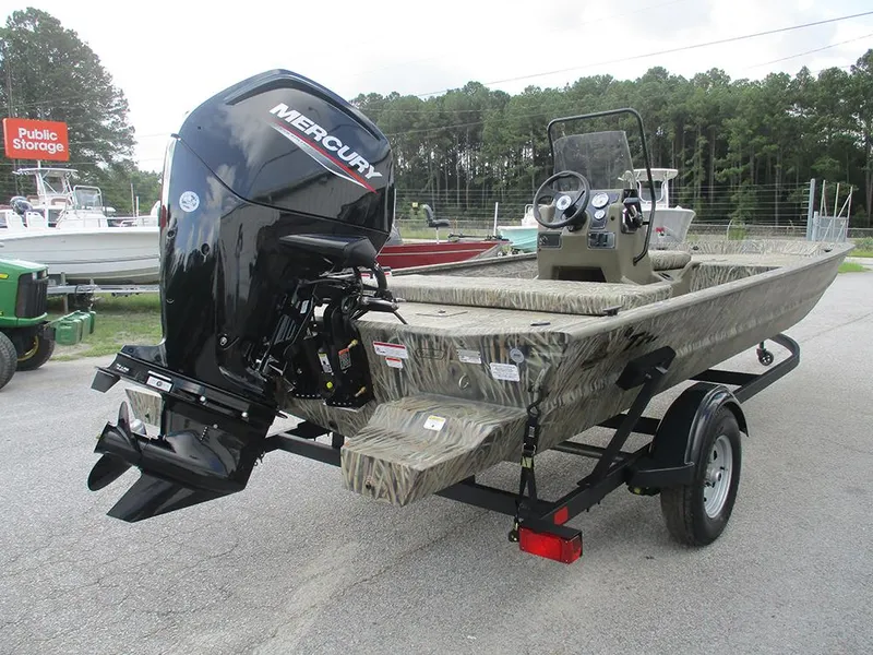 Slide: The Image of 2026 Tracker Grizzly 1860 CC boat with Mercury engine on trailer, parked outdoors. - 6