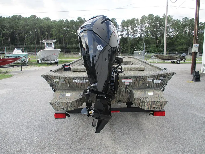 Slide: The Image of 2026 Tracker Grizzly 1860 CC boat with camo design and powerful outboard motor. - 7