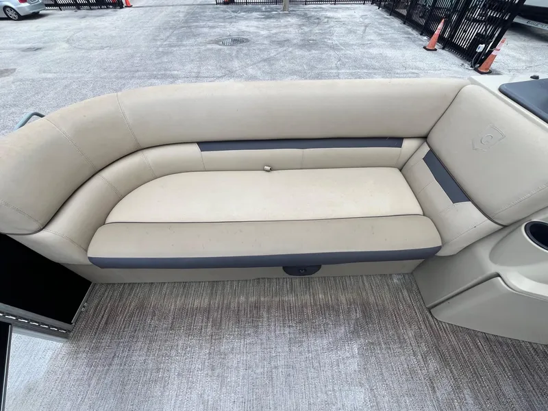 Slide: The Image of Beige seating on 2022 Godfrey Sweetwater 2286 FS pontoon boat, outdoor setting. - 8