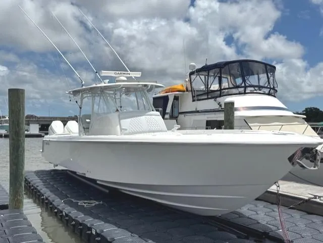 Slide: The Image of 2021 Contender 39 Fisharound boat docked under a cloudy sky. - 10