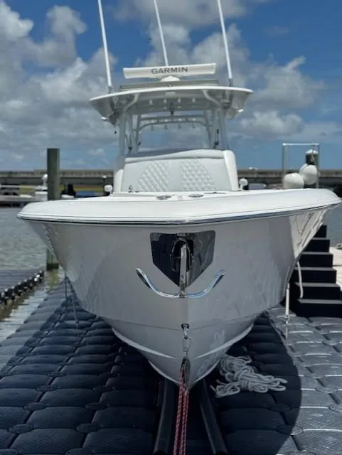 Slide: The Image of 2021 Contender 39 Fisharound boat docked, featuring sleek design and Garmin equipment. - 12