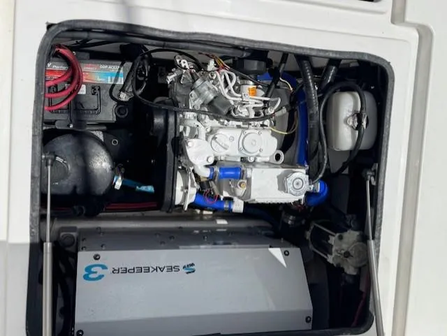 Slide: The Image of Engine compartment of a 2021 Contender 39 Fisharound boat, showcasing mechanical components. - 13