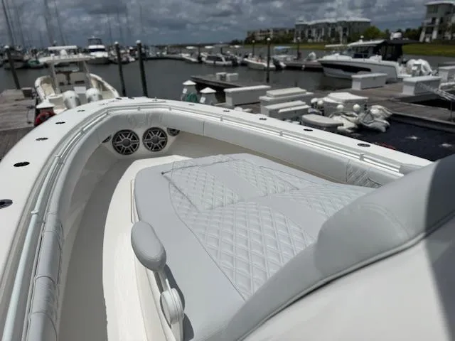 Slide: The Image of 2021 Contender 39 Fisharound boat with cushioned seating at marina. - 16