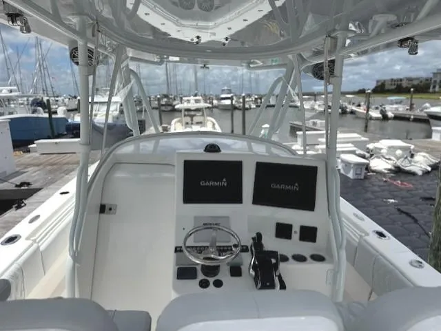 Slide: The Image of 2021 Contender 39 Fisharound boat dashboard with Garmin displays at marina. - 17