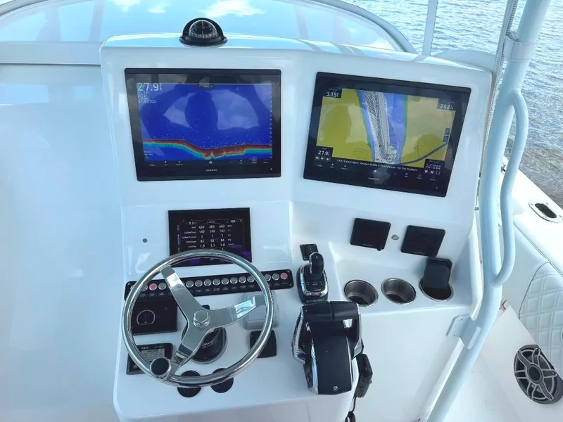Slide: The Image of 2021 Contender 39 Fisharound helm with dual navigation screens and steering wheel. - 18
