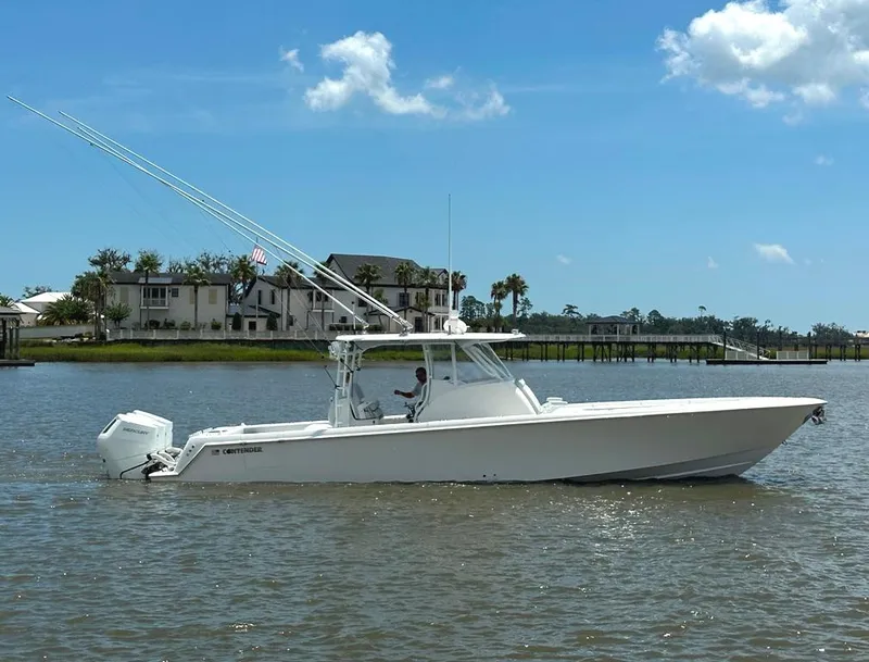 Slide: The Image of 2021 Contender 39 Fisharound boat on calm water, clear sky background. - 3