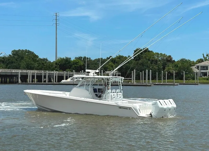 Slide: The Image of 2021 Contender 39 Fisharound boat cruising on a sunny day with fishing rods. - 6