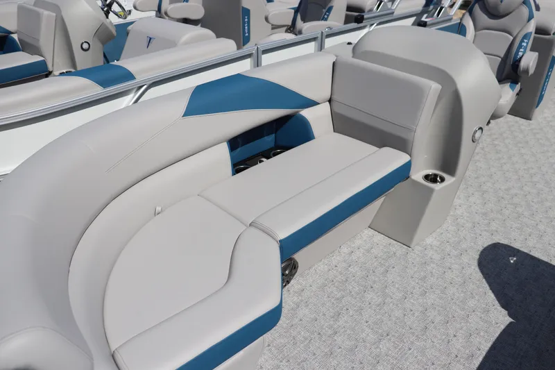 Slide: The Image of 2025 Trifecta LE Series 24RF LE boat interior with gray and blue seating. - 2