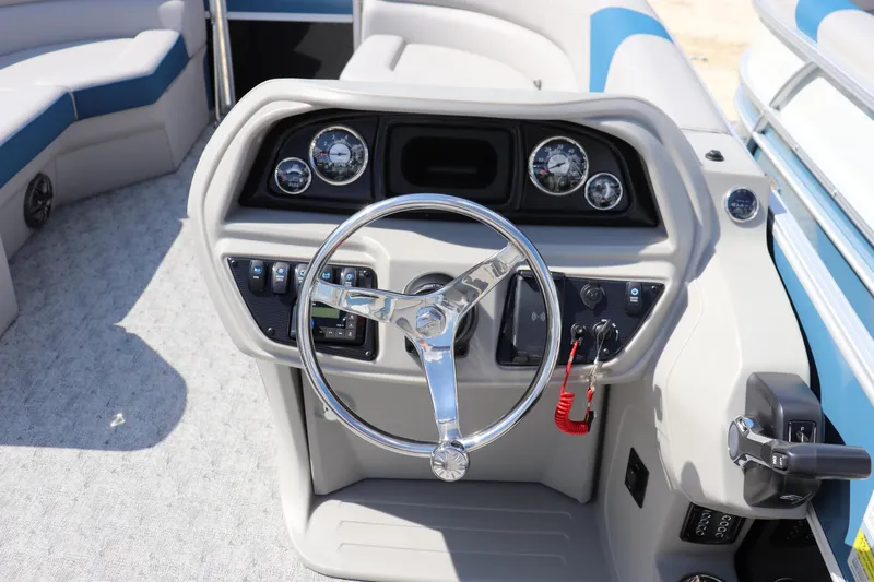 Slide: The Image of Steering console of 2025 Trifecta LE Series 24RF LE pontoon boat, featuring modern controls and gauges. - 5