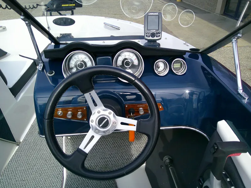 Slide: The Image of 2015 Glastron GT 180 Ski & Fish boat dashboard with steering wheel and gauges. - 10